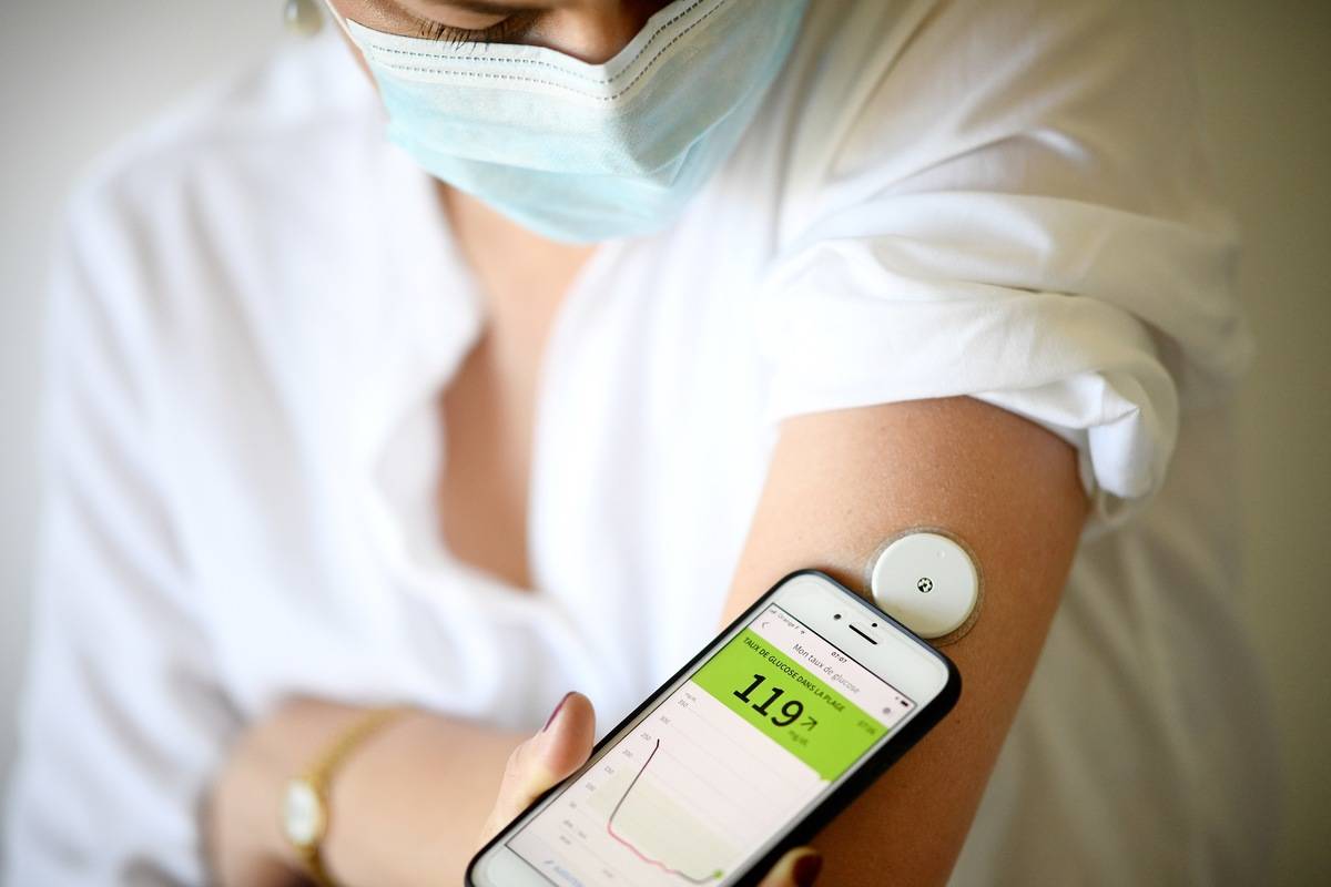 A woman with diabetes measures her blood sugar.