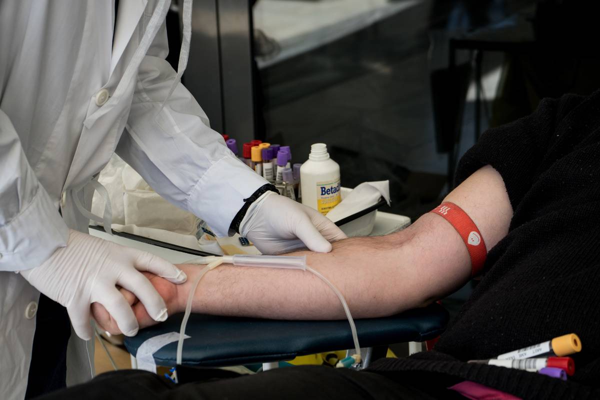 A doctor tests a donor's blood.