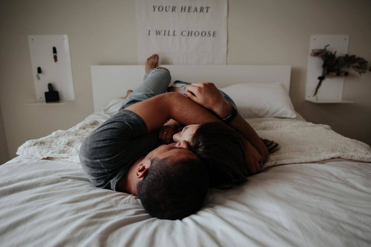 man and woman embrace in bed