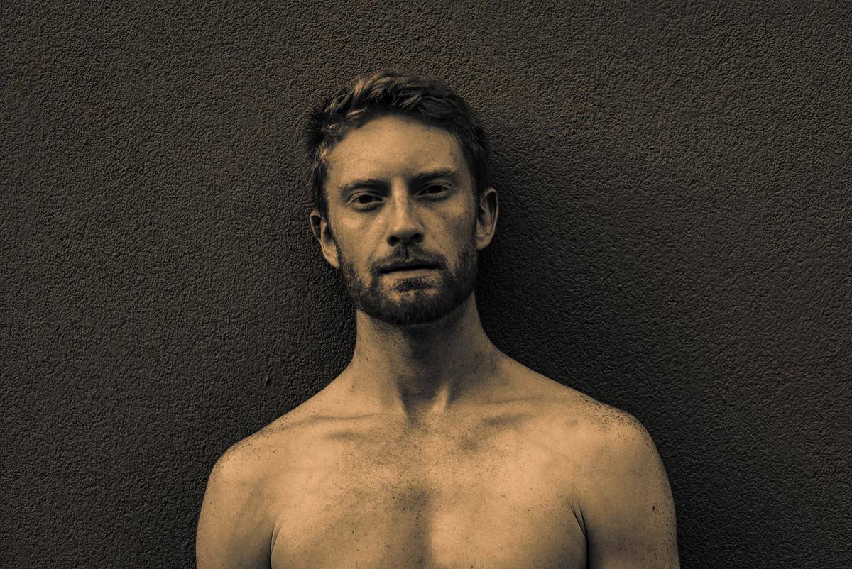 man shows off his lack of chest hair