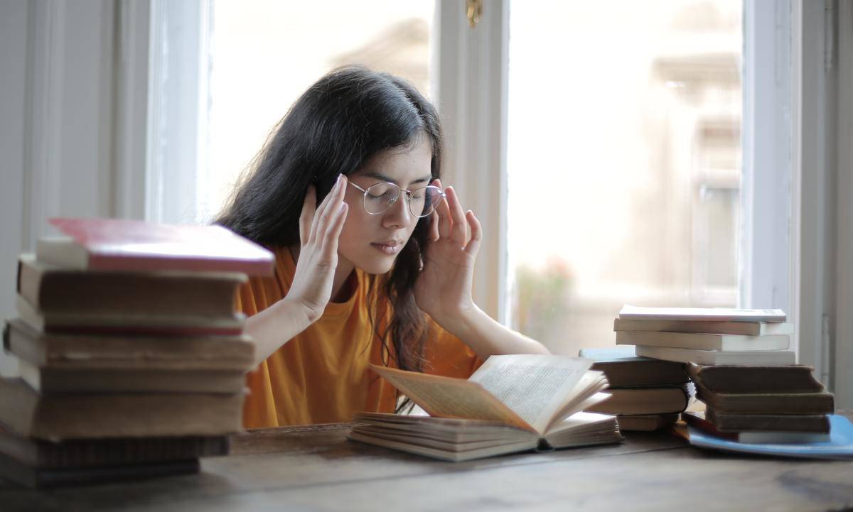 woman at table with textbooks