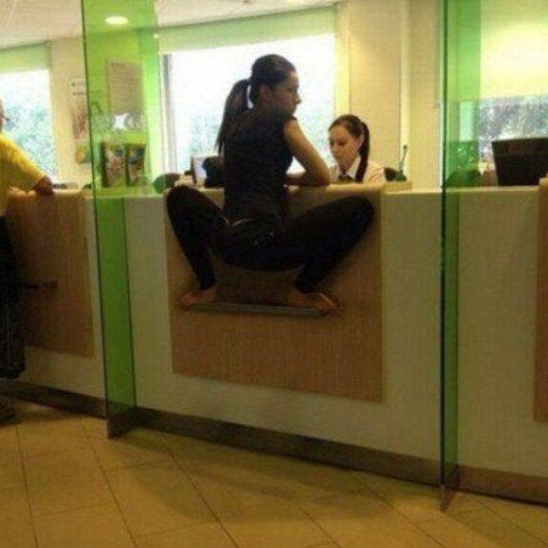 someone standing on the side of the teller's box