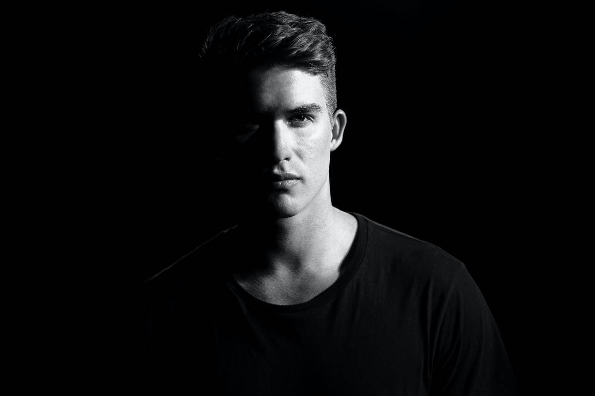 man staring directly into camera black and white shadows