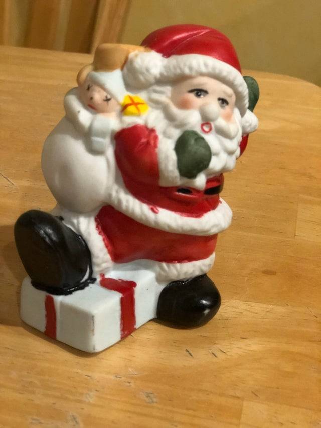 Santa figurine with baby in sack