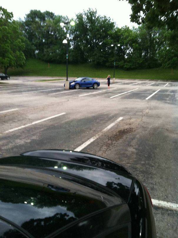 car crashed into pole in empty parking lot.