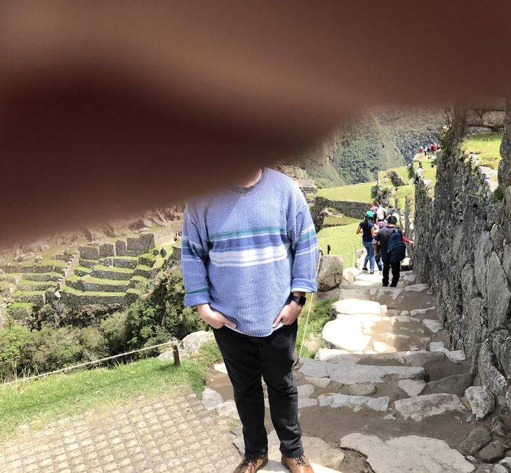 dad has finger over lens while taking picture of son