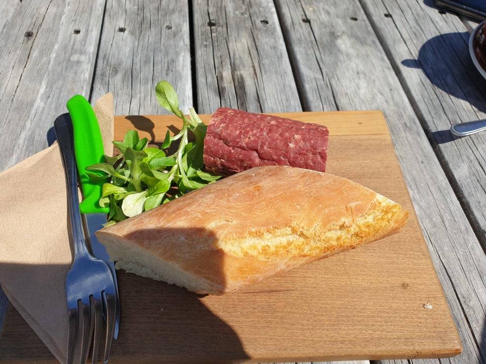 salami and baguette uncut on wooden board