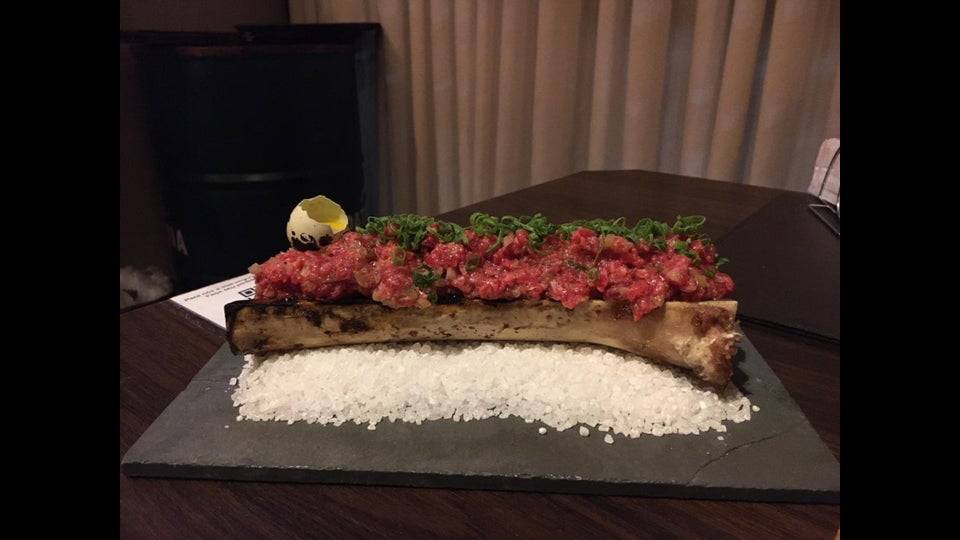 steak tartare served on bone on a bed of salt