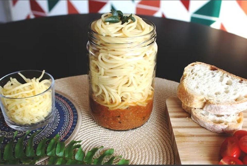 spaghetti in a jar with sauce at the bottom