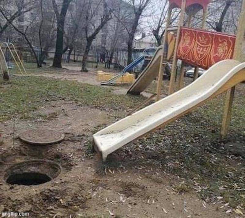 playground slide leads to manhole