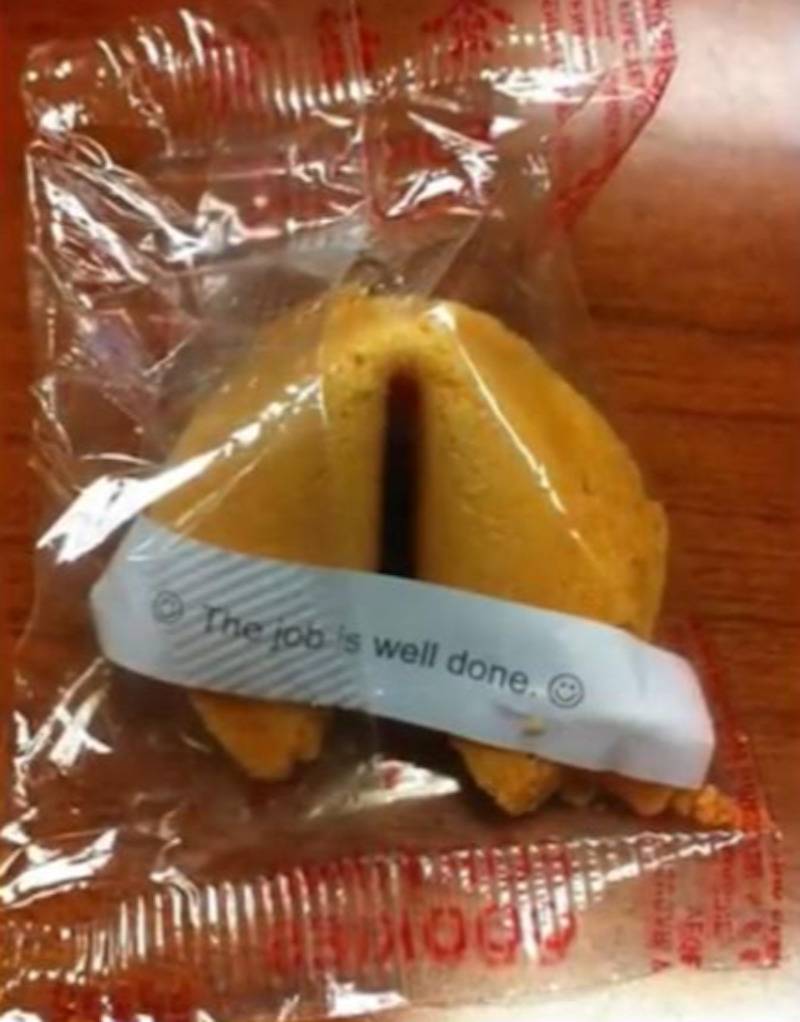 fortune cookie with fortune outside of the cookie