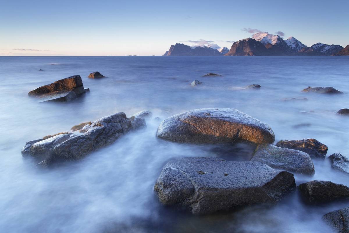 Fog covers the shoreline of Utakleiv Beach.