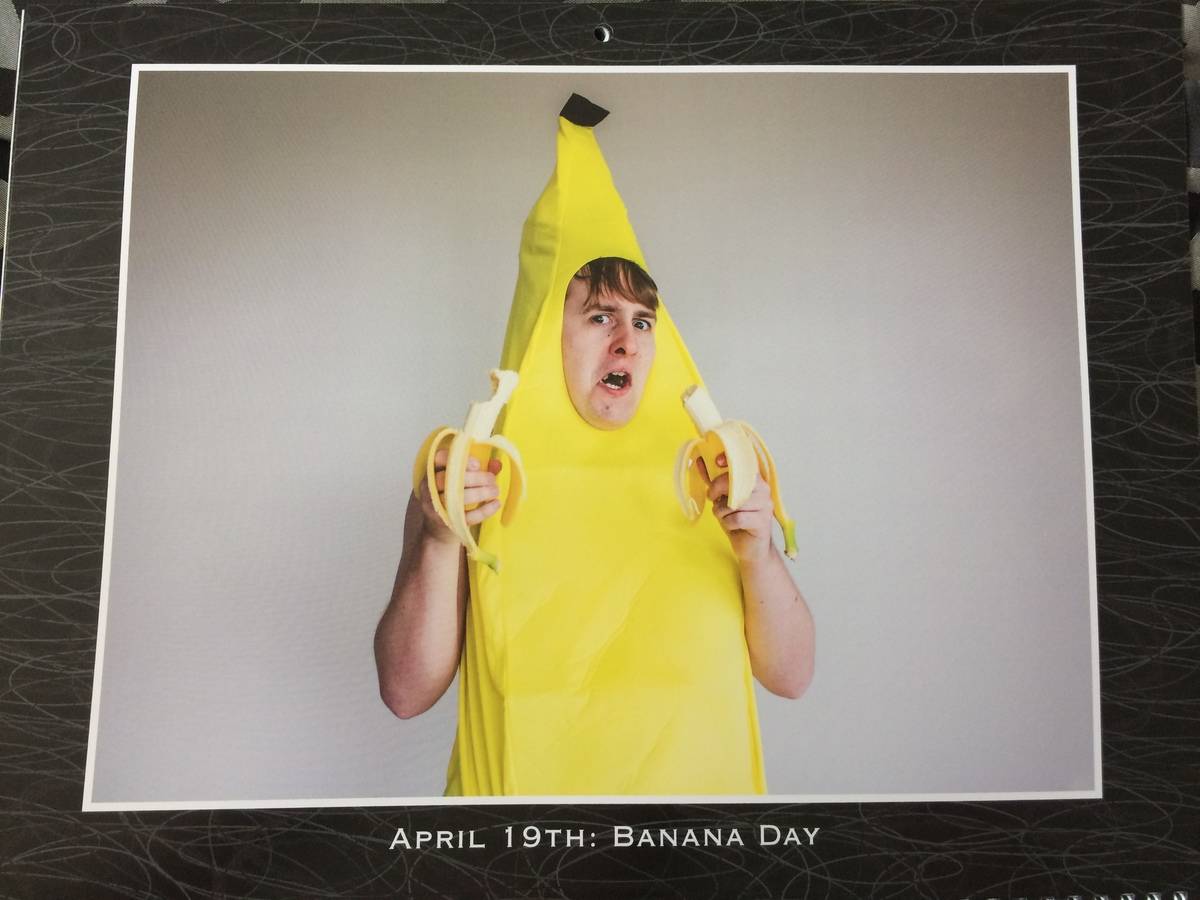 man wearing banana costume and eating bananas