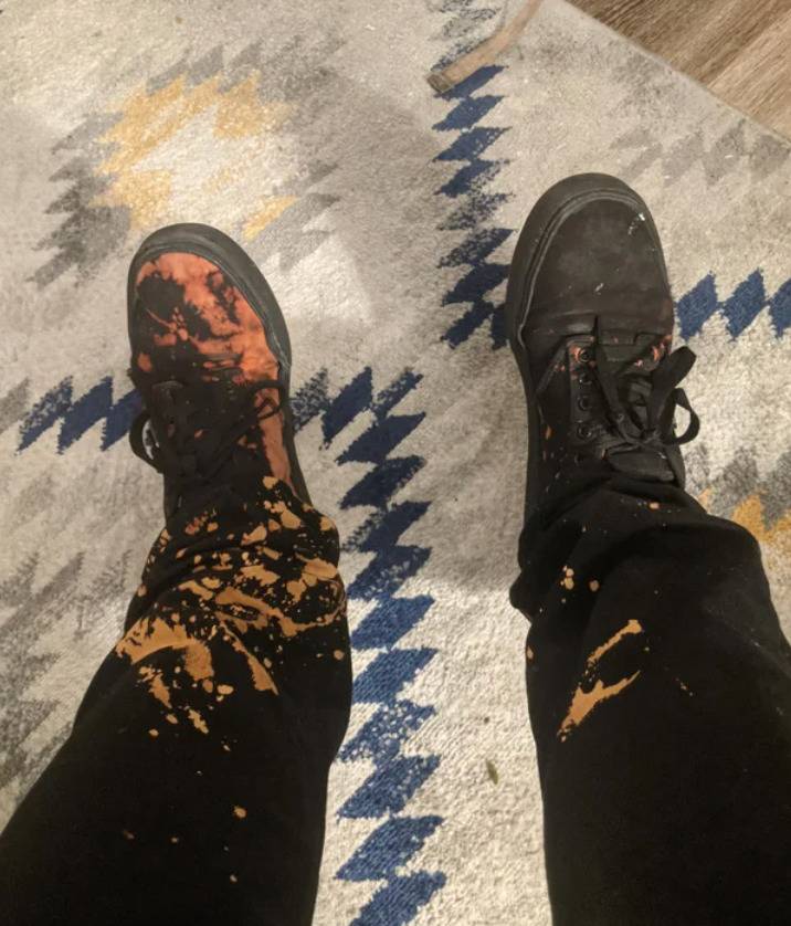 black pants and shoes stained with bleach