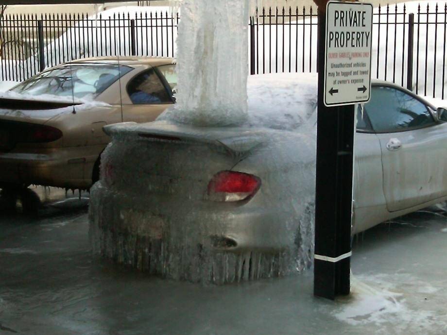 car completely covered in ice in the winter