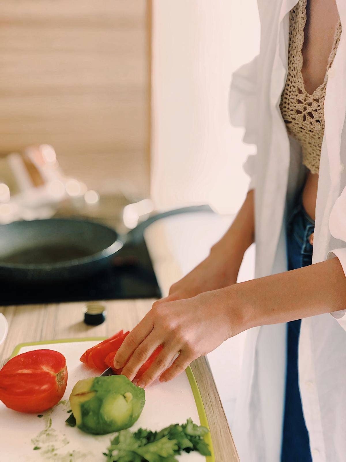 a woman cutting up some vegetables