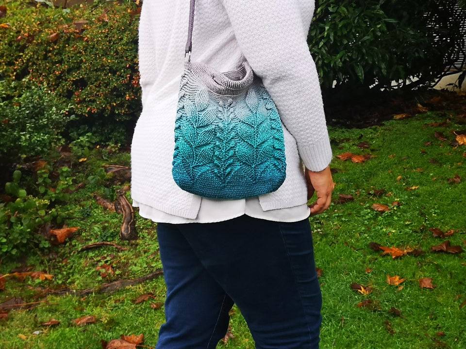 woman carrying blue crochet bag