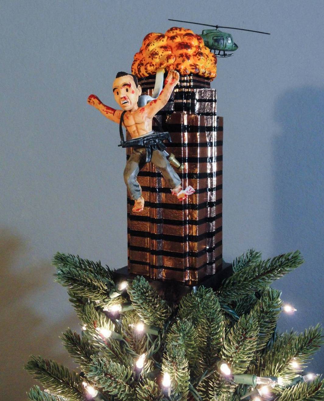 tree topper features john McClane jumping from building that's exploding in Die Hard