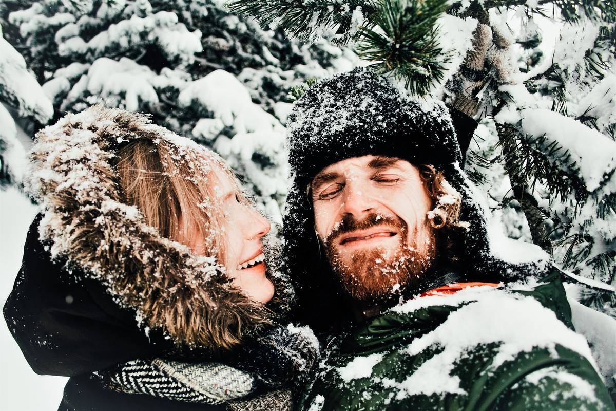 man and woman covered in snow