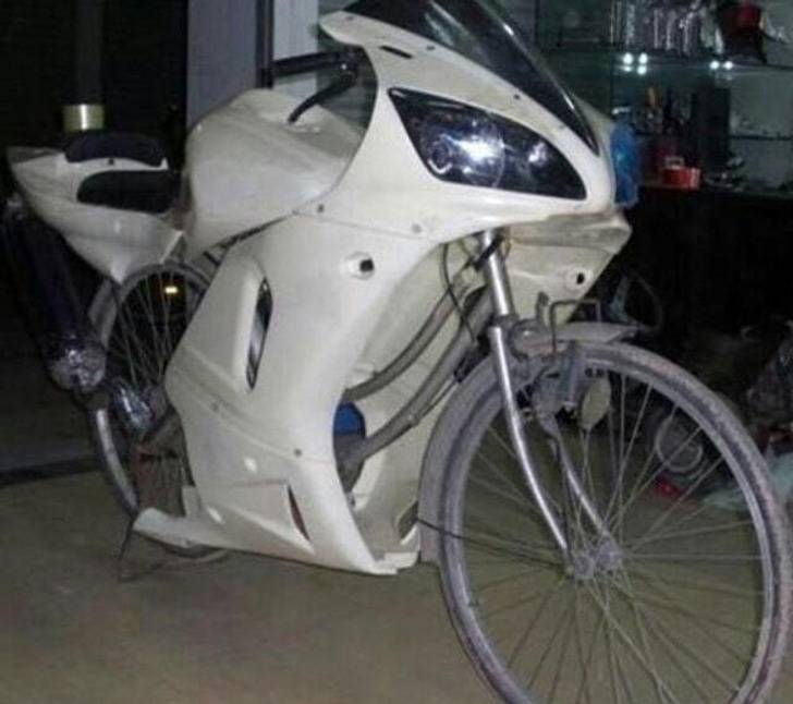 bicycle with shell of motorbike on top of it