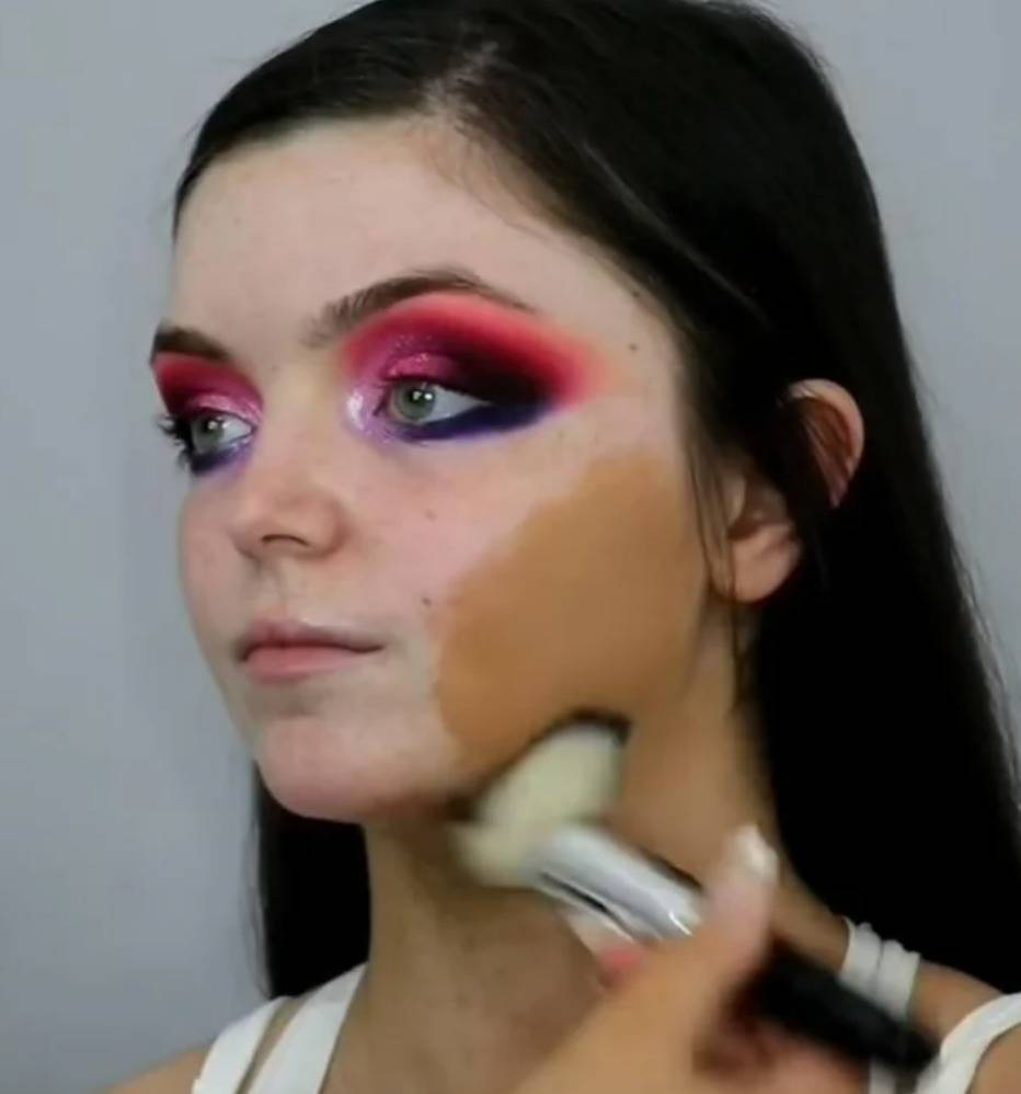 person applying foundation the colour of peanut butter onto a very pale person