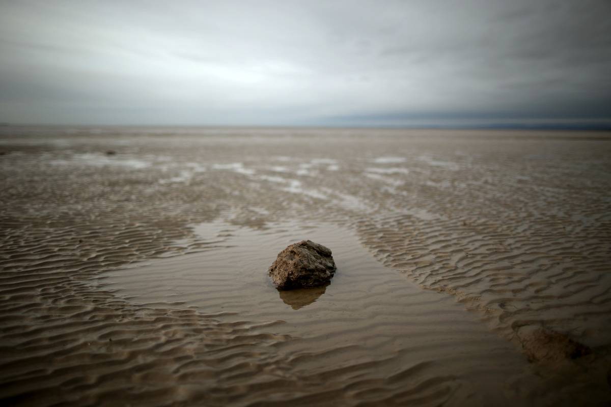 Quicksand is seen on the long shore of Morecambe Beach, England.