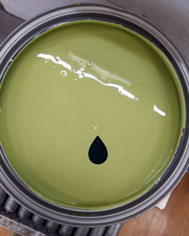 A teardrop of black in pea-green paint