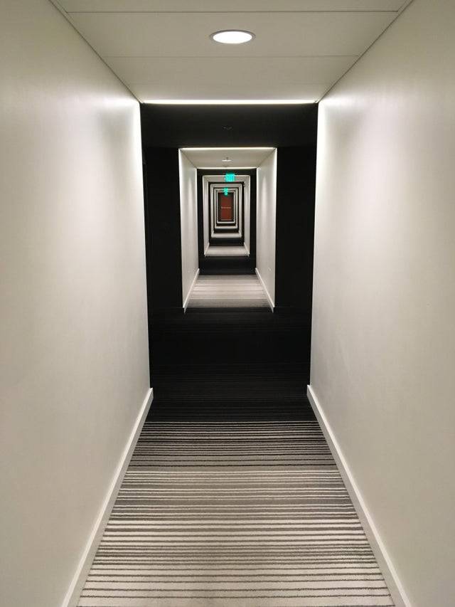 trippy hallway with strange lighting that makes it look like multiple black boxes to walk through