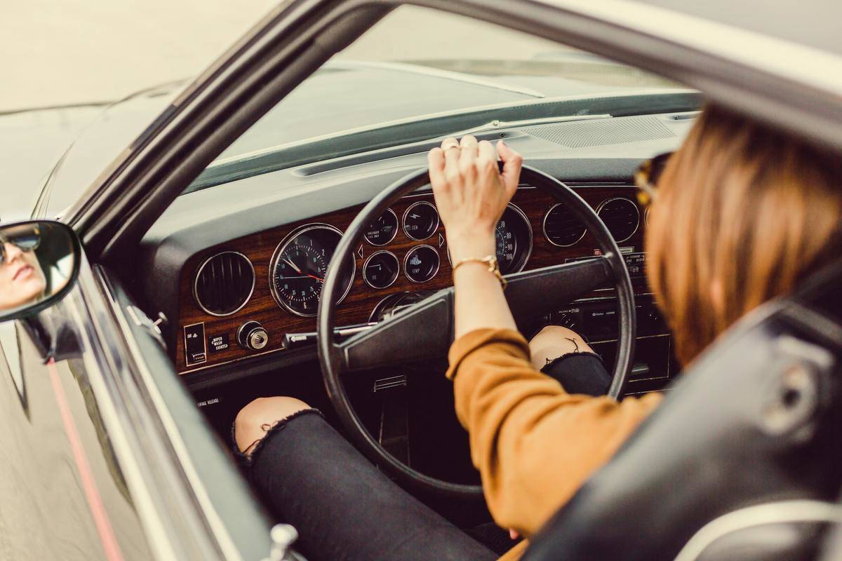 woman driving a vintage car