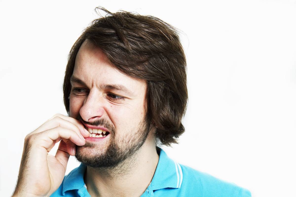 A man bites his nails.