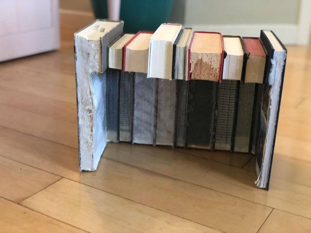 Books glued together, with pages cut out
