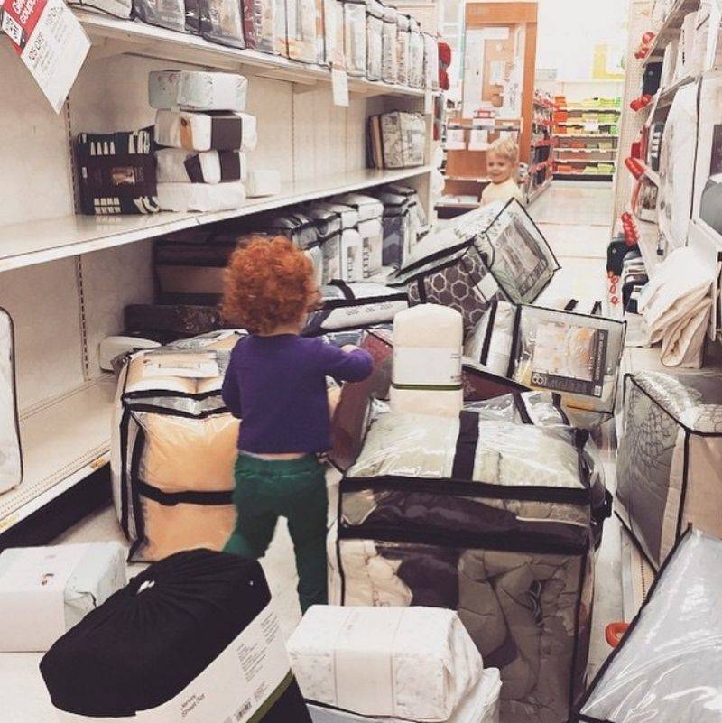 Two kids who took all the duvet sets off the shelf 