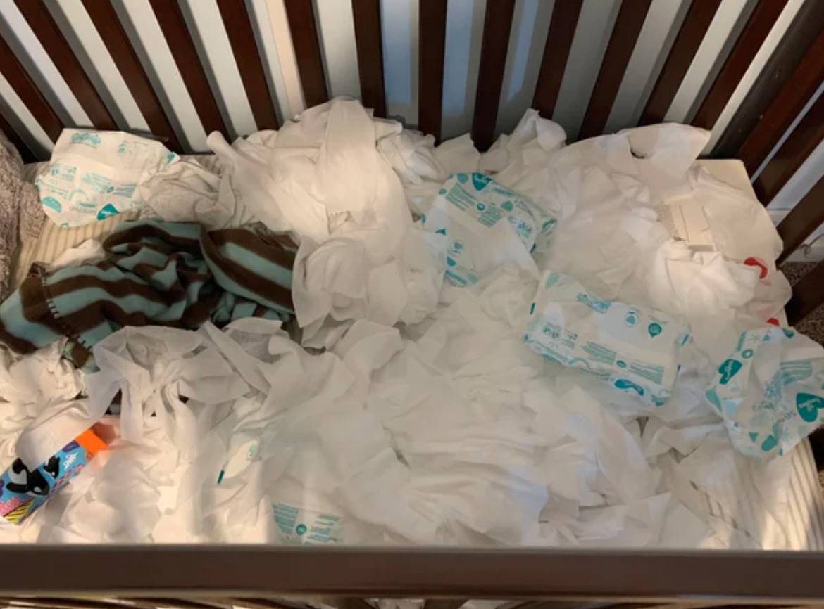 hundreds of baby wipes strewn across crib