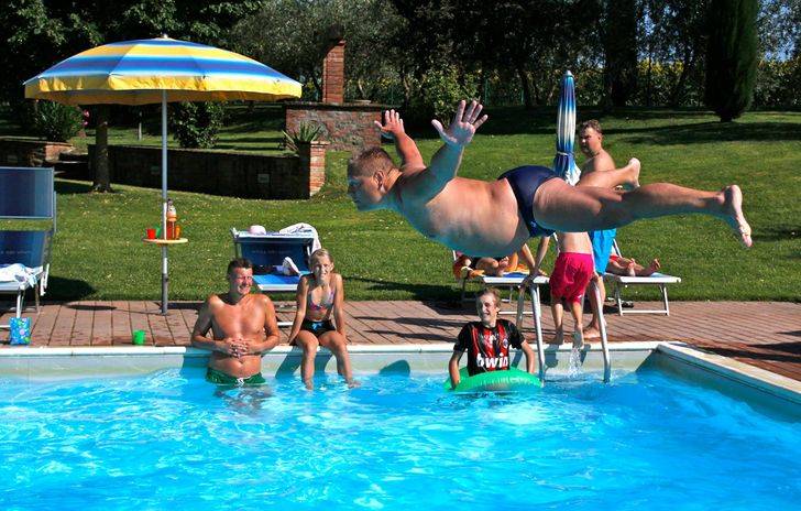 Man about to hit the water in a belly flop