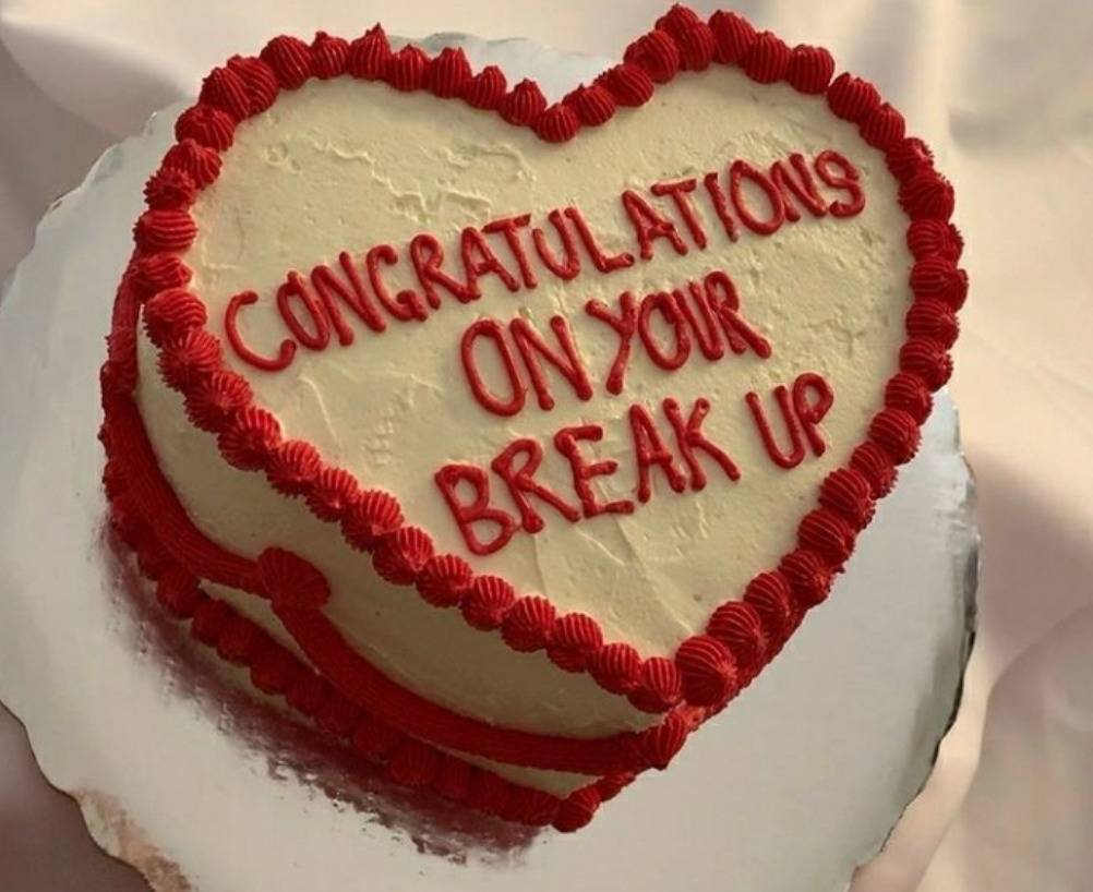 heart shaped cake with writing: congrats on your break up