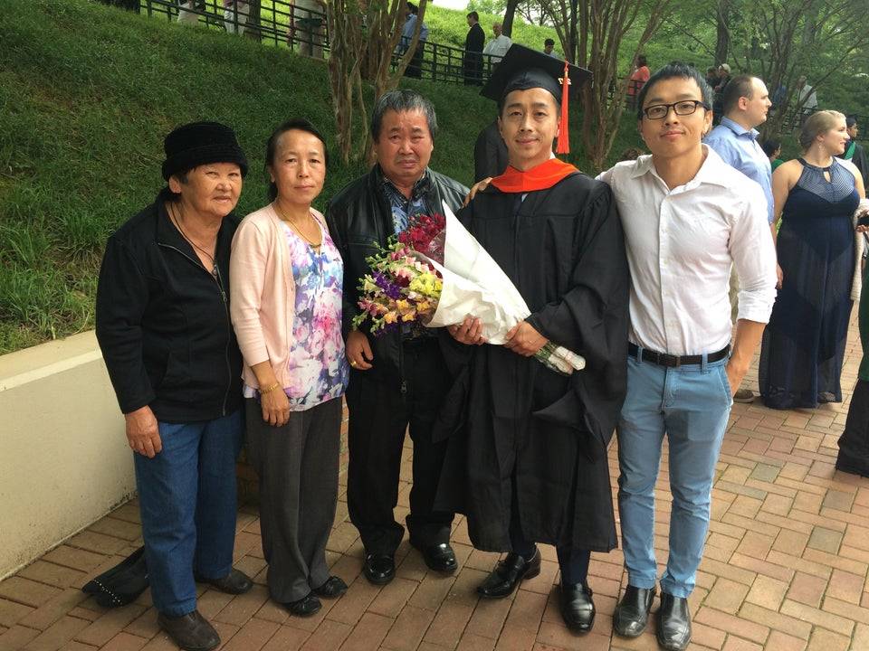 family celebrating child being first to graduate with master's degree, dad can't stop crying