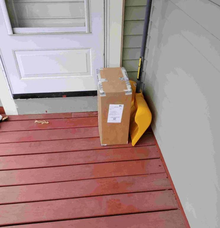 boxed delivery sitting on someone's front porch near door