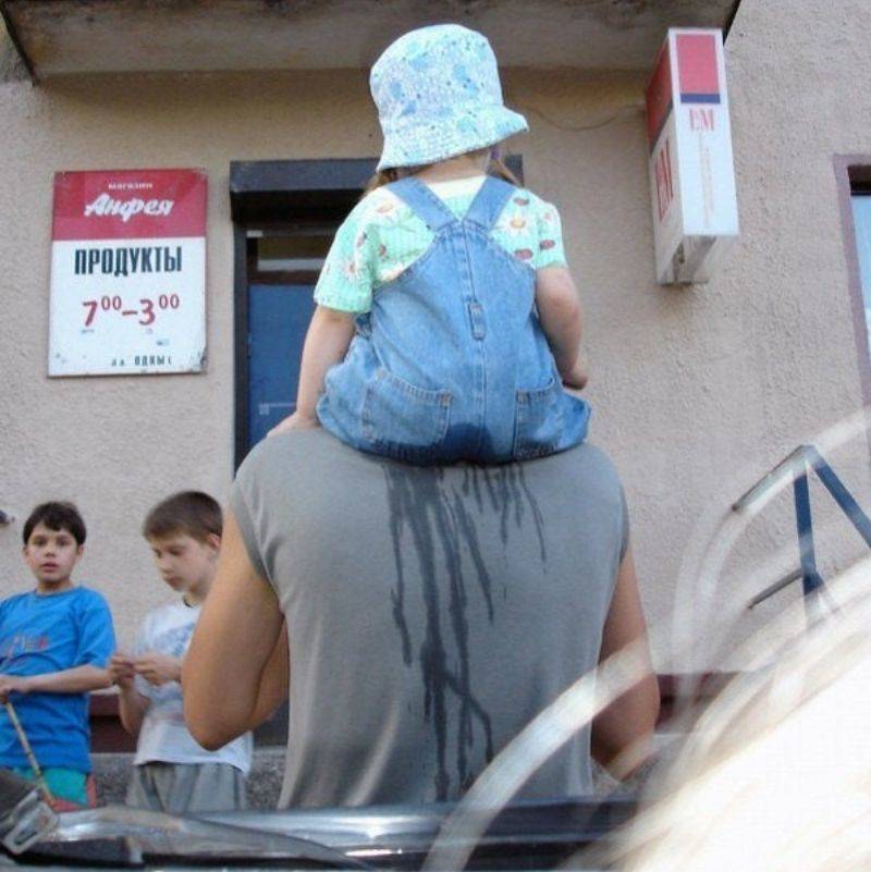 a baby on someone's shoulders who wet their pants 