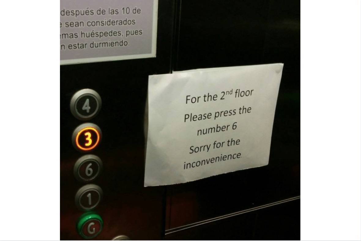 elevator sign in hotel reads confusing directions to press button