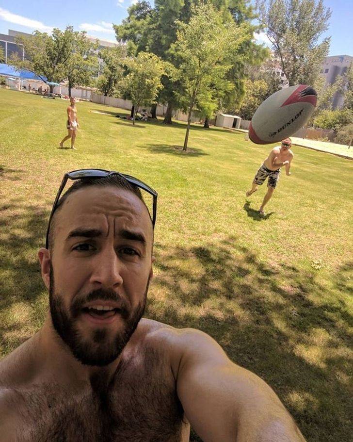 man taking a selfie moments before being beaned in the head by a football