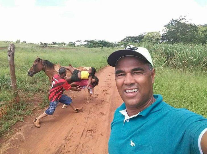 Dad taking picture while his kids fall off a horse