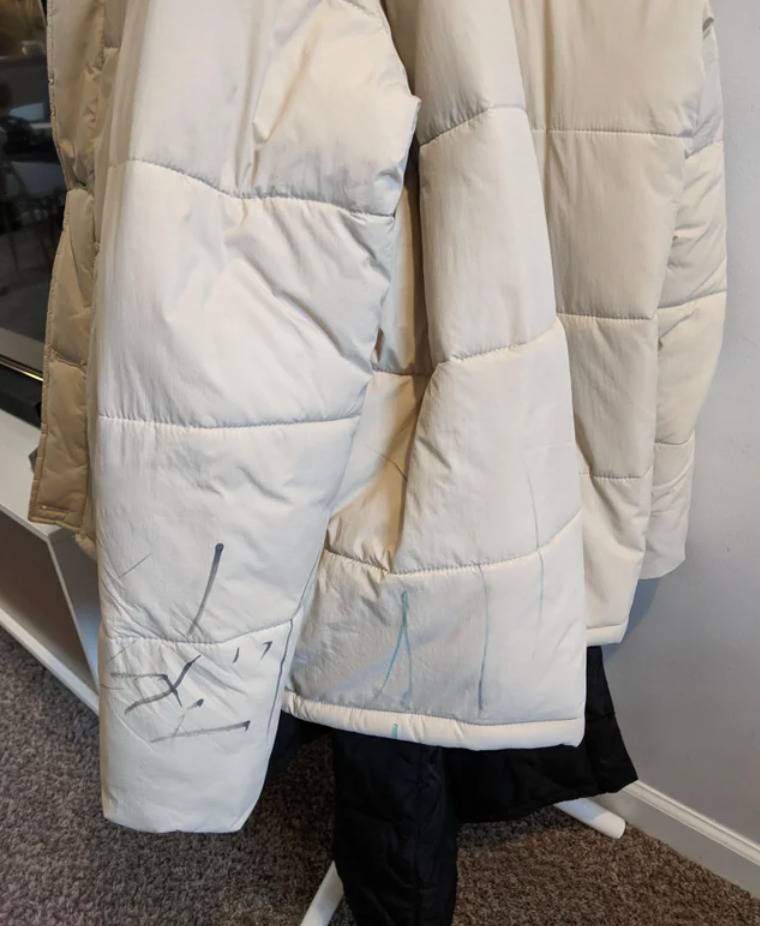off-white coat with marker scribbles drawn on it
