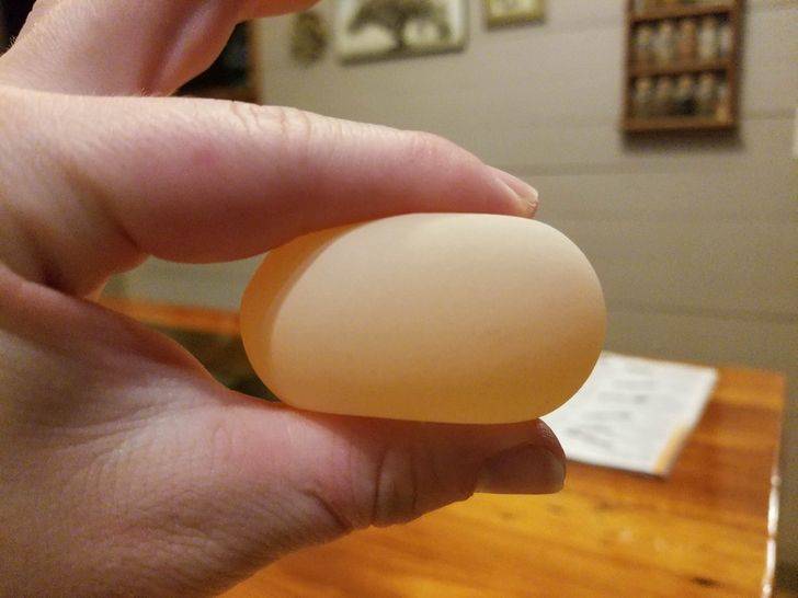 person squishing egg membrane