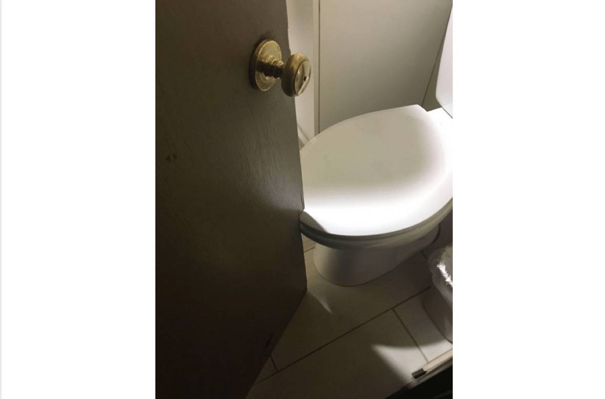 motel bathroom has door that hits toilet when opened