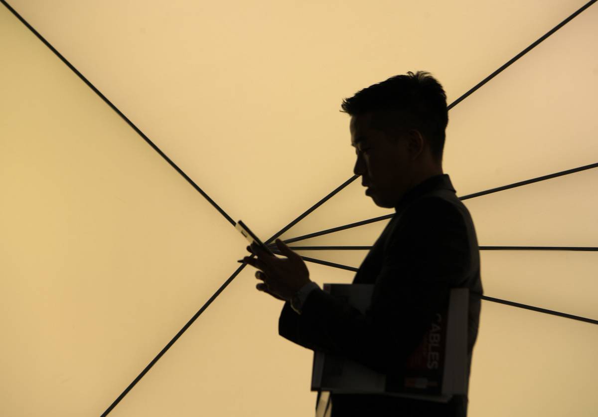 A man looks at his iPhone.