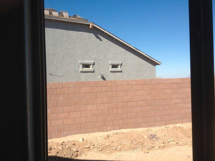 windows on home make it look like it is glowering over the fencing