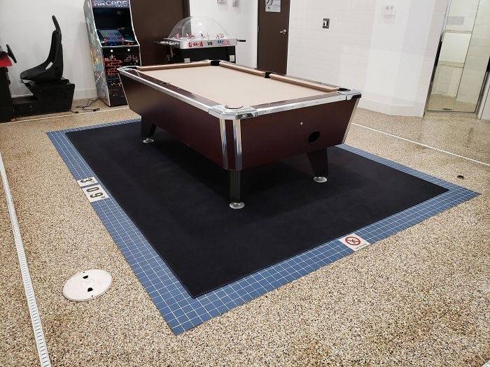 pool table in arcade onto of blue tiled swimming pool outline