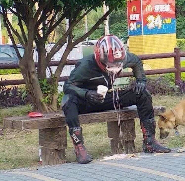person attempted to drink a milkshake while wearing motorcycle helmet, and it's a mess