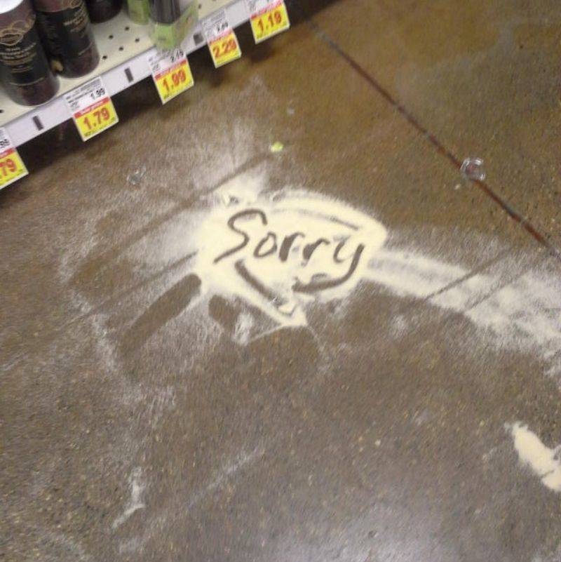 someone wrote 'sorry' in a pile of spilled flour 