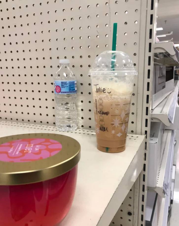 mostly full starbucks drink abandoned on a shelf of a store